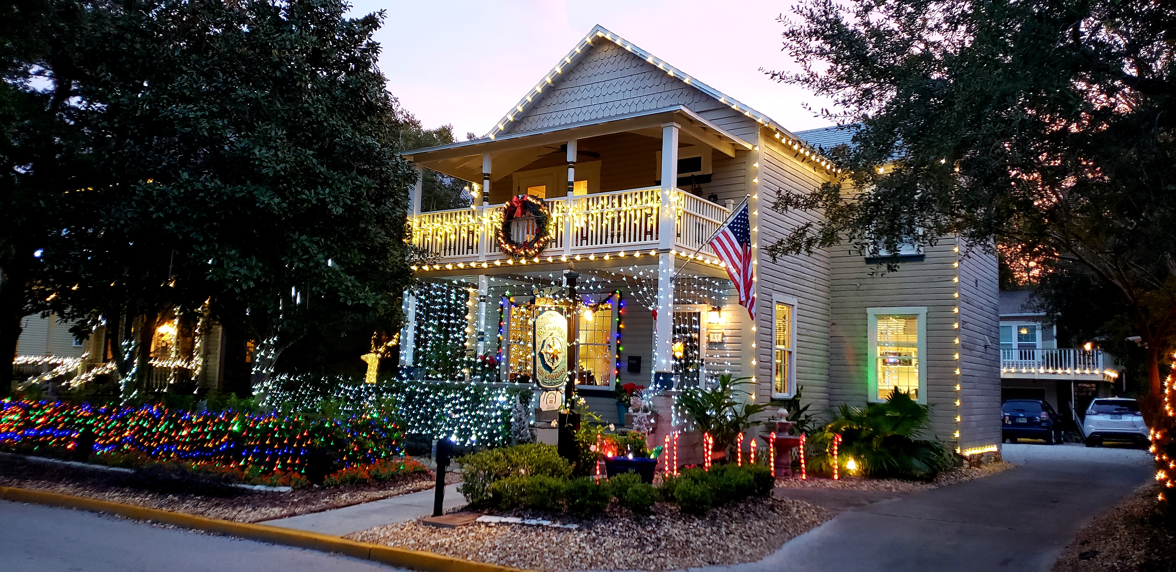 Photo of Inn's front exterior at dusk with Holiday Lights glowing